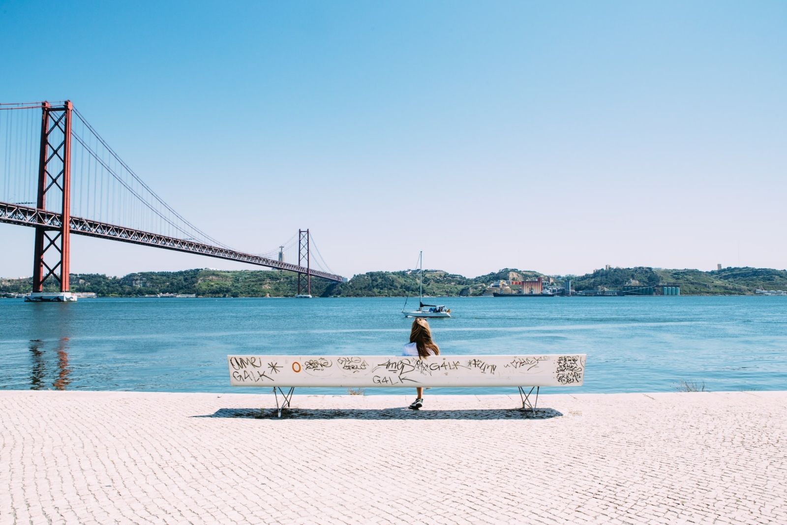 Woman and the traditional Lisbon bridge