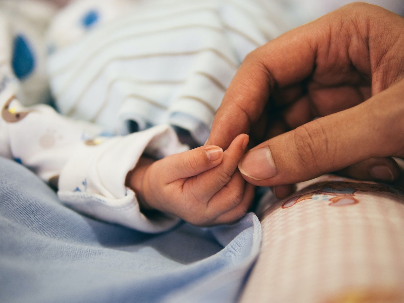 Mom holding baby's hand