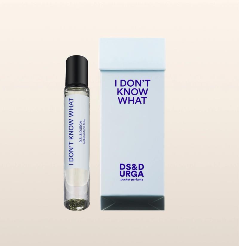 A sleek, roll-on bottle of "i don't know what" perfume oil, next to its minimalist packaging.