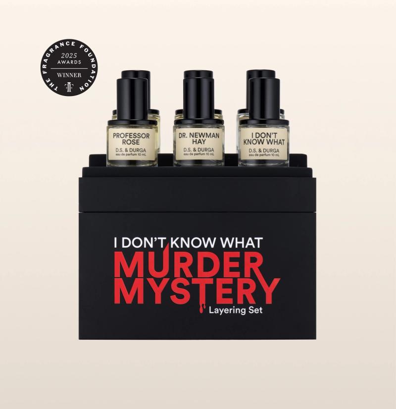Six perfume bottles are displayed on a box labeled "I Don't Know What Murder Mystery Layering Set" by D.S. & Durga. The bottles are named "Professor Rose," "Dr. Newman," and "I Don't Know What." A sticker shows it won a 2025 award.