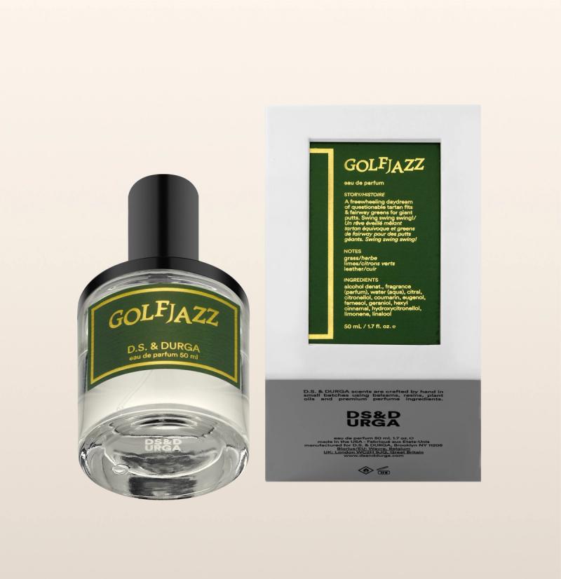 A bottle of D.S. & Durga Golf Jazz eau de parfum sits next to its box. Both feature green and yellow labels with text, displaying the product name and fragrance details on a light beige background.