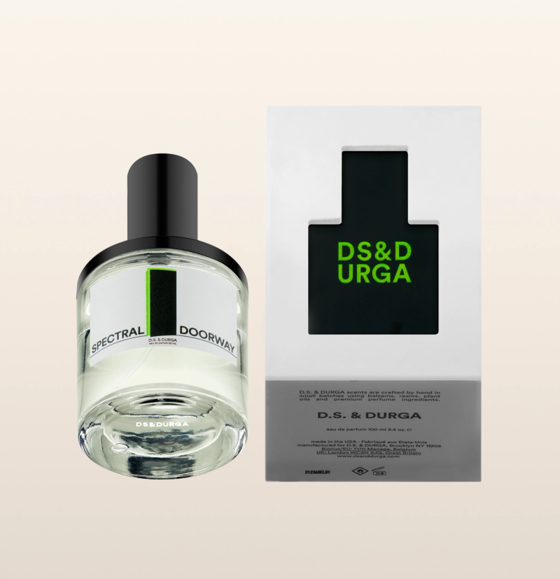 A bottle of D.S. & DURGA "Spectral Doorw" perfume with its packaging. The round bottle has a black cap and blue label. Beside it, the box shows detailed product information and description on the back, including ingredients and fragrance notes.