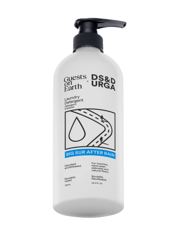 White bottle of Guests on Earth x D.S. & Durga laundry detergent with black pump, labeled Big Sur After Rain, shown against a light gray background.