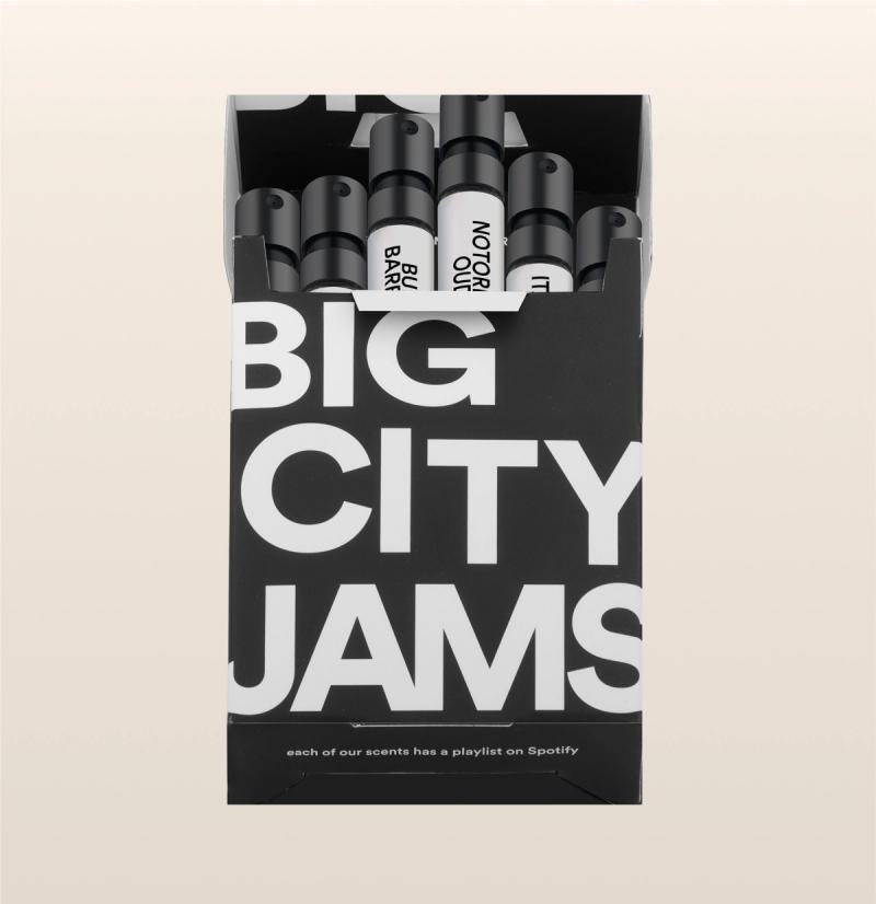 A box containing a collection of "big city jams" perfumes, with a note stating that each of the scents is paired with a playlist on spotify.