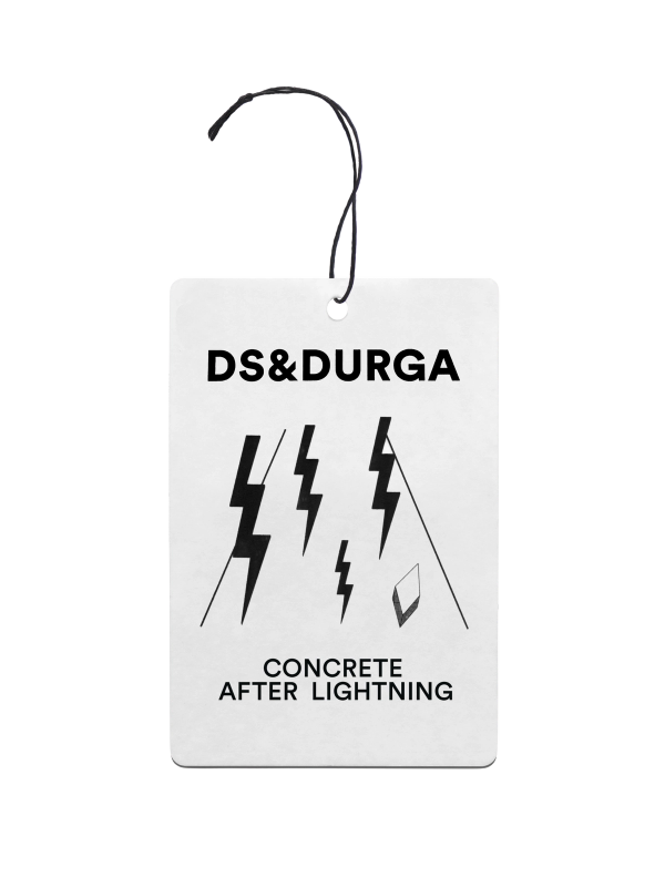 A hanging auto fragrance with the inscription "ds &amp; durga" and the scent name "concrete after lightning," adorned with lightning bolt graphics.