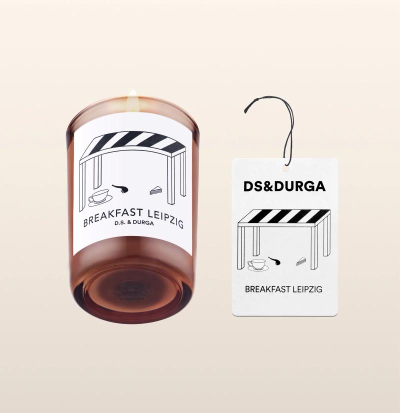 An elegant, lit scented candle by d.s. & durga with breakfast leipzig fragrance, accompanied by a matching auto fragrance. 