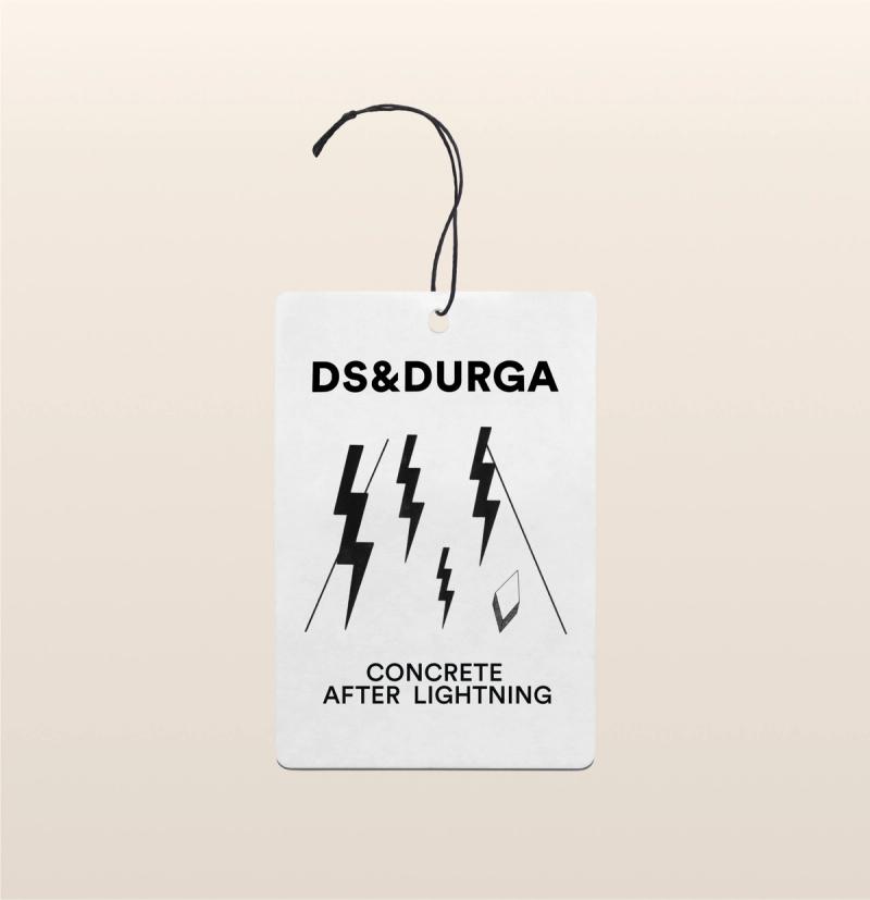 A hanging auto fragrance with the inscription "ds &amp; durga" and the scent name "concrete after lightning," adorned with lightning bolt graphics.