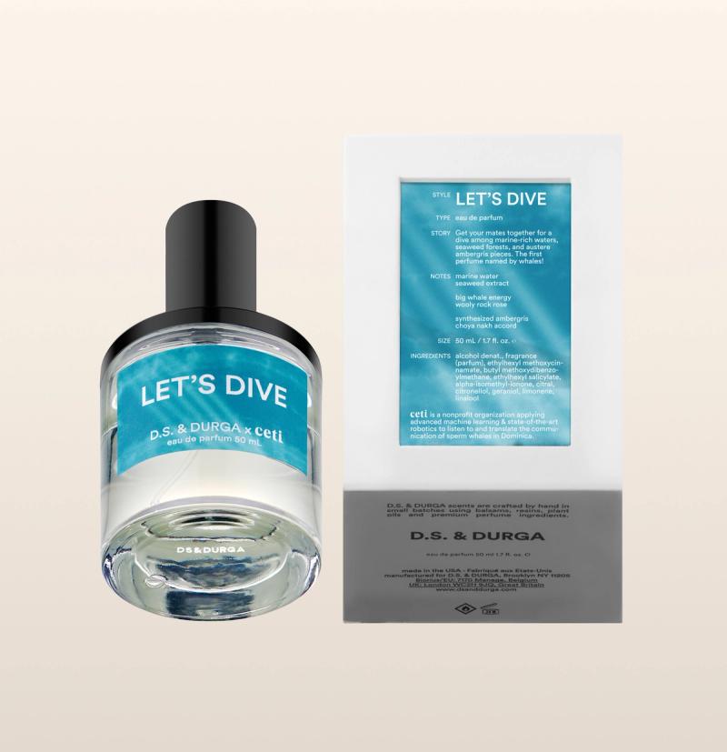 A bottle of D.S. & DURGA "Let's Dive" perfume with its packaging. The round bottle has a black cap and blue label. Beside it, the box shows detailed product information and description on the back, including ingredients and fragrance notes.