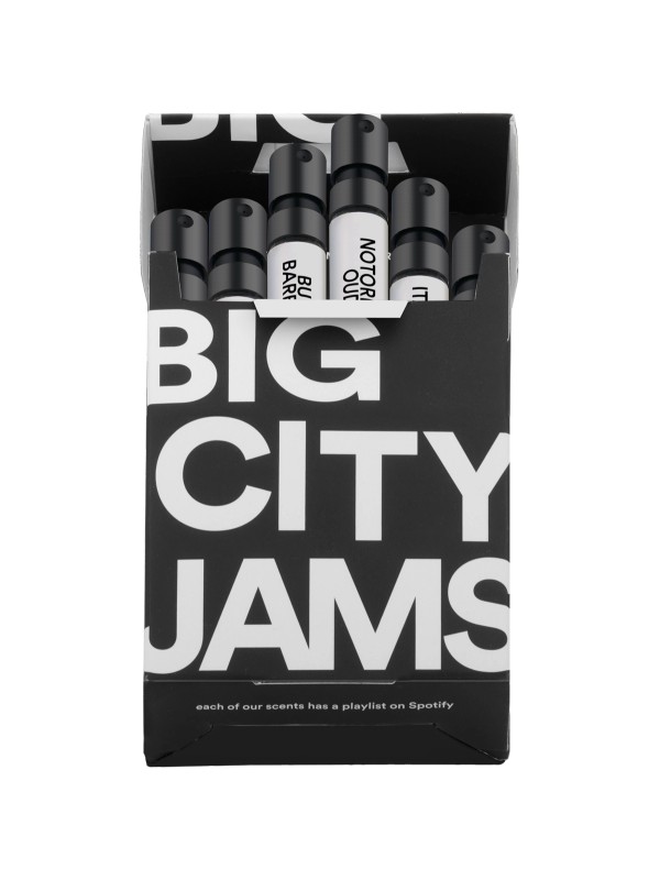 A box containing a collection of "big city jams" perfumes, with a note stating that each of the scents is paired with a playlist on spotify.