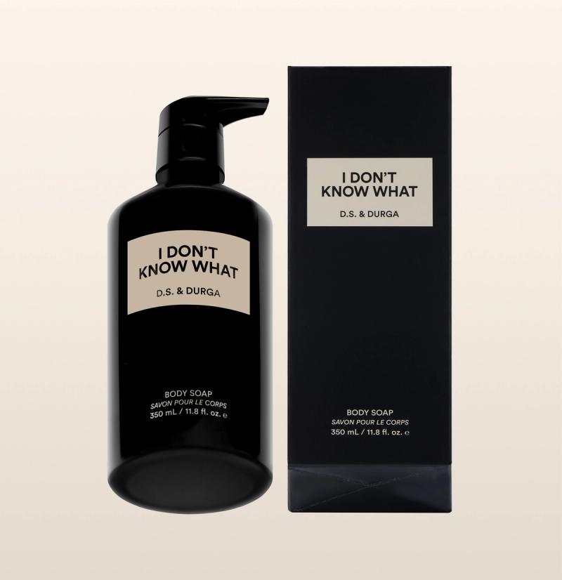 A black pump bottle and matching box labeled "I DON’T KNOW WHAT D.S. &amp; DURGA," containing body soap, 350 mL (11.8 fl. oz.), with minimalist beige and black design on a light background.