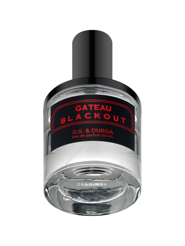 A clear glass perfume bottle labeled "gateau blackout d.s. & durga eau de parfum 50 ml" with a black cap, isolated on a clear background.