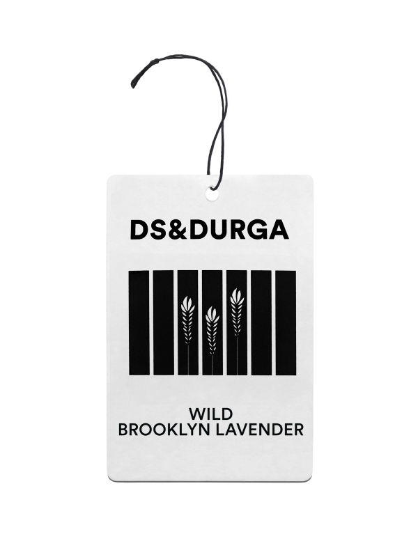 A hanging auto fragrance with the inscription"ds & durga" on the upper portion and "wild brooklyn lavender" below.