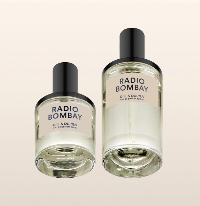 Two clear glass perfume bottles labeled "RADIO BOMBAY D.S. & DURGA," one 50 ml and one 100 ml, with black caps, displayed against a light beige background.