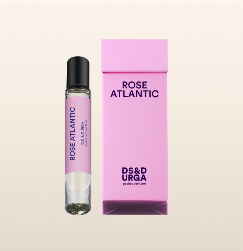 A sleek, roll-on bottle of "rose atlantic" perfume oil, next to its minimalist packaging.