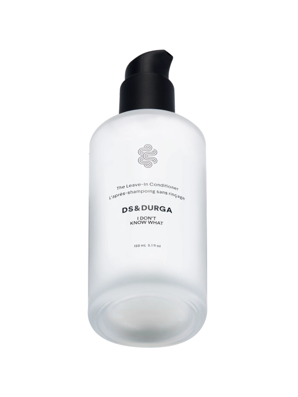 A frosted pump bottle labeled "DS & DURGA I Don't Know What The Leave-in Conditioner," containing 150 mL (5.1 fl oz), with minimalist black text and a coiled design logo.