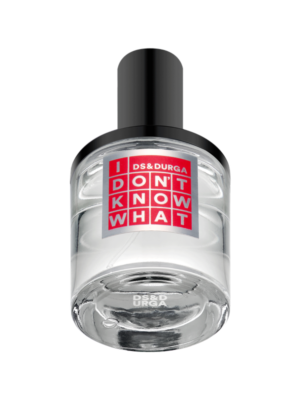 A clear glass perfume bottle with a black cap. The label reads "DS & DURGA DON'T KNOW WHAT" in white and red block letters. The bottle contains a transparent liquid.