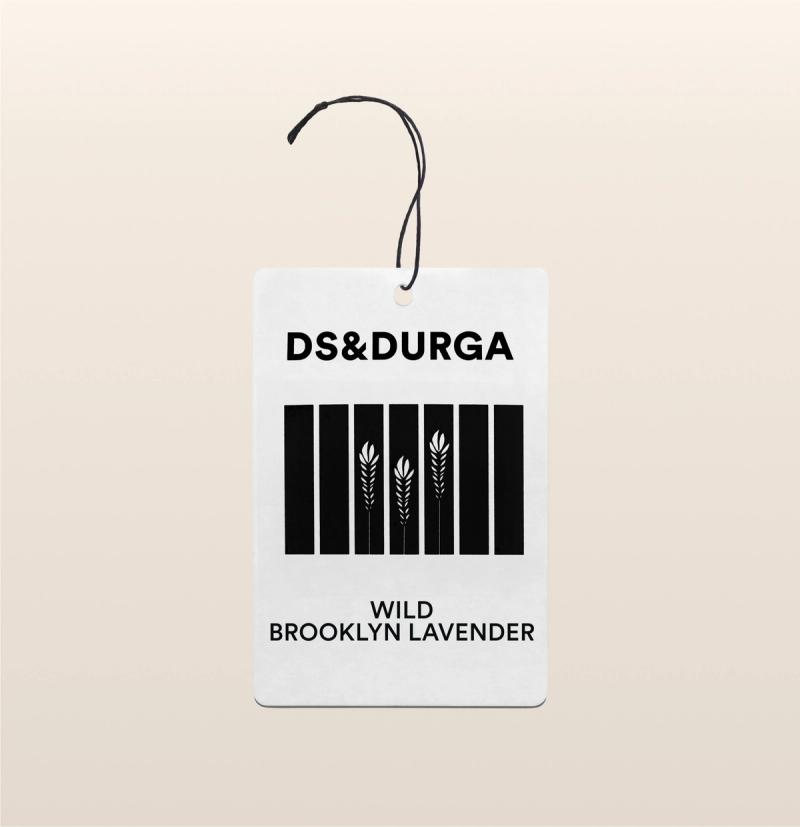 A hanging auto fragrance with the inscription"ds & durga" on the upper portion and "wild brooklyn lavender" below.