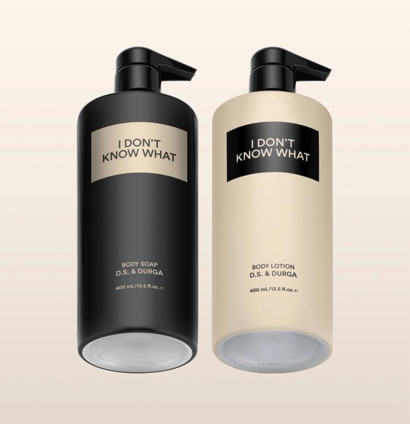 Two aluminum bottles labeled "I Don't Know What" by D.S. & Durga, one body soap and one body lotion against a neutral background.