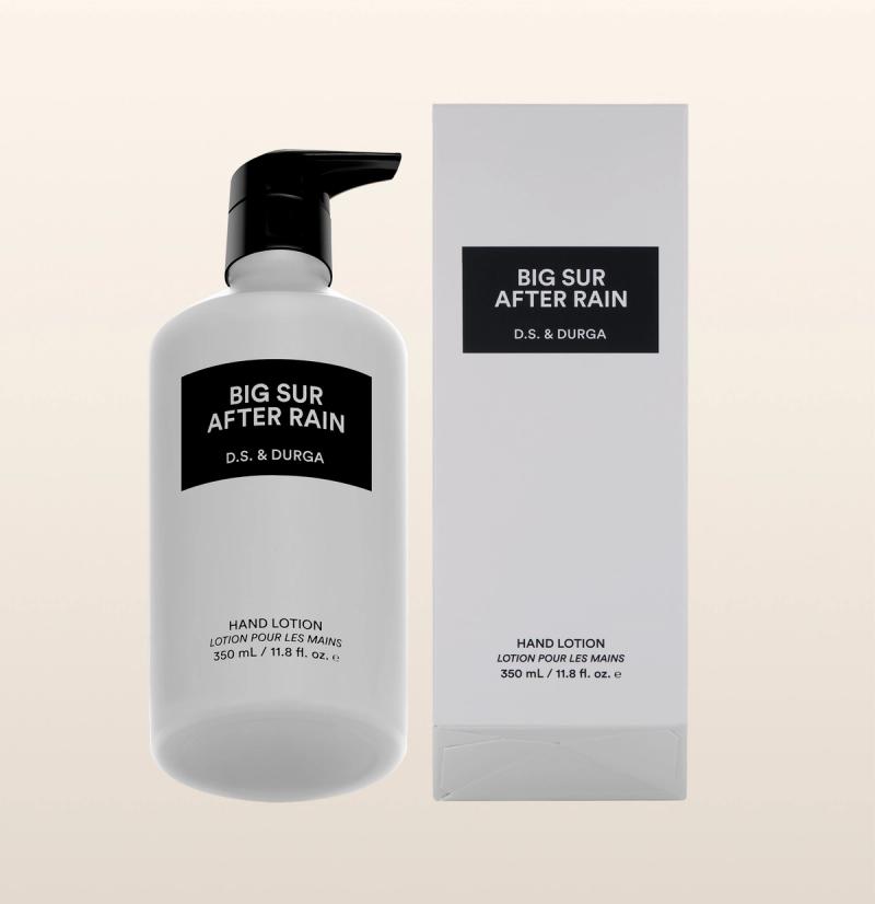 A white bottle with a black pump labeled "Big Sur After Rain D.S. & Durga" next to a matching white box with the same label. Both indicate "Hand Lotion, 350 mL / 11.8 fl. oz.
