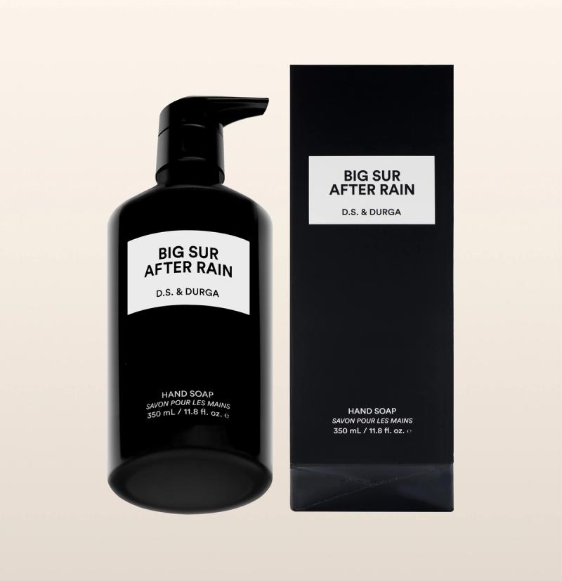 A black bottle of D.S. & Durga Big Sur After Rain hand soap with a pump sits next to its matching black box. Both display the product name in bold text on white labels. The bottle contains 350 ml (11.8 fl. oz.).