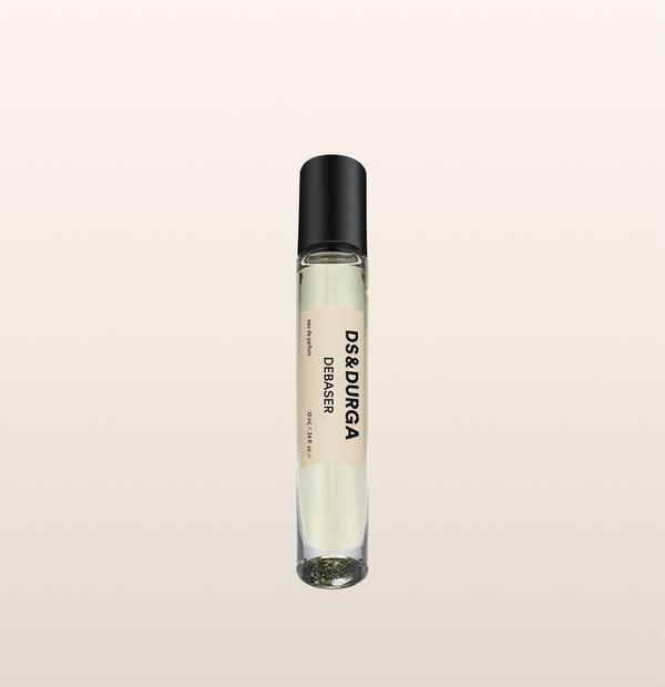 A sleek 10 mL travel size perfume spray bottle labeled “Debaser” by d.s. & durga, with a black cap and cream label.
