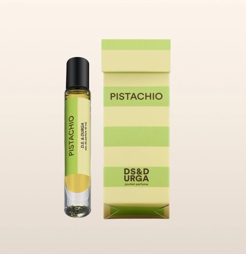 A sleek, roll-on bottle of "pistachio" perfume oil, next to its minimalist packaging.