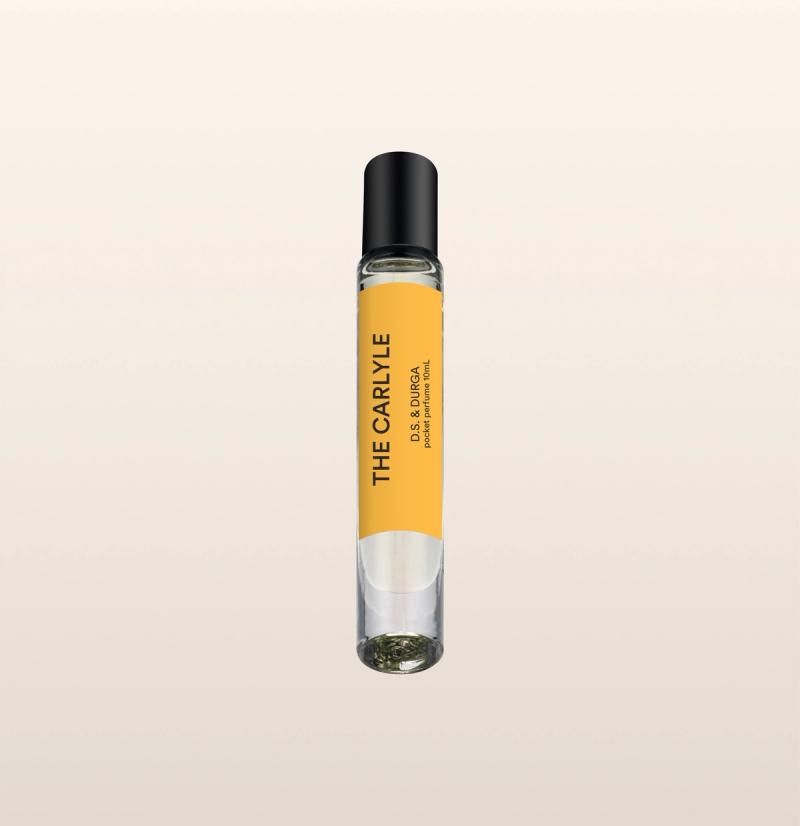 A sleek spray perfume bottle with a yellow label that reads "the carlyle" by d.s. & durga.