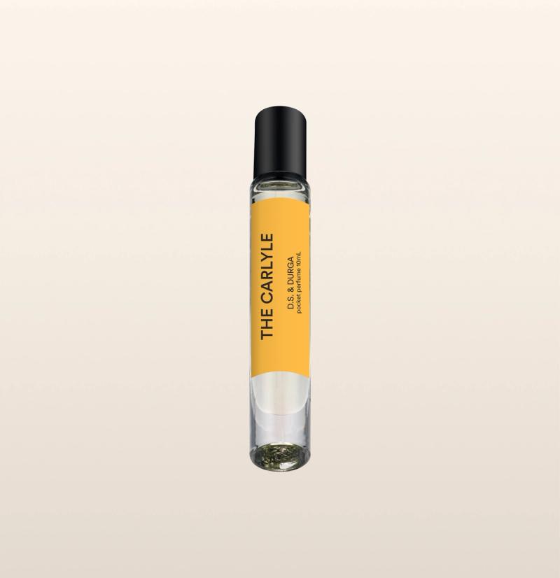 A sleek spray perfume bottle with a yellow label that reads "the carlyle" by d.s. &amp; durga. 