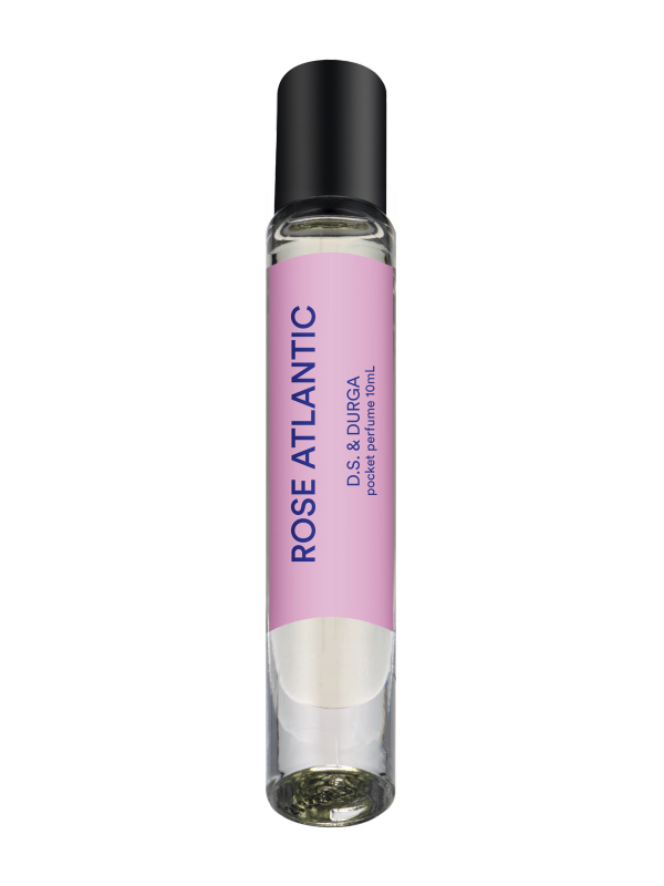 A sleek rollerball perfume bottle with a pink label that reads "rose atlantic" by d.s. &amp; durga. 