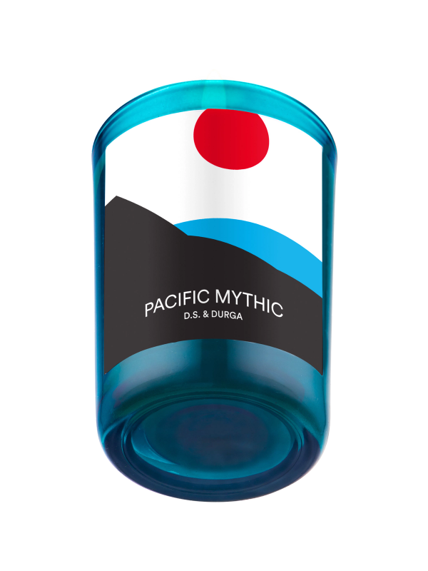 A lit scented candle with a blue gradient, labeled "pacific mythic" d.s. &amp; durga. 