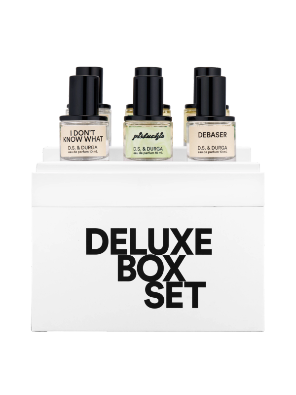 A set of six upscale d.s. &amp; durga mini perfume bottles displayed on top of a sleek box labeled "deluxe box set".