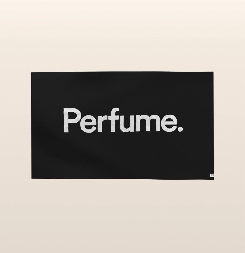 A large black beach towel with the word "perfume" written in a simple white font.