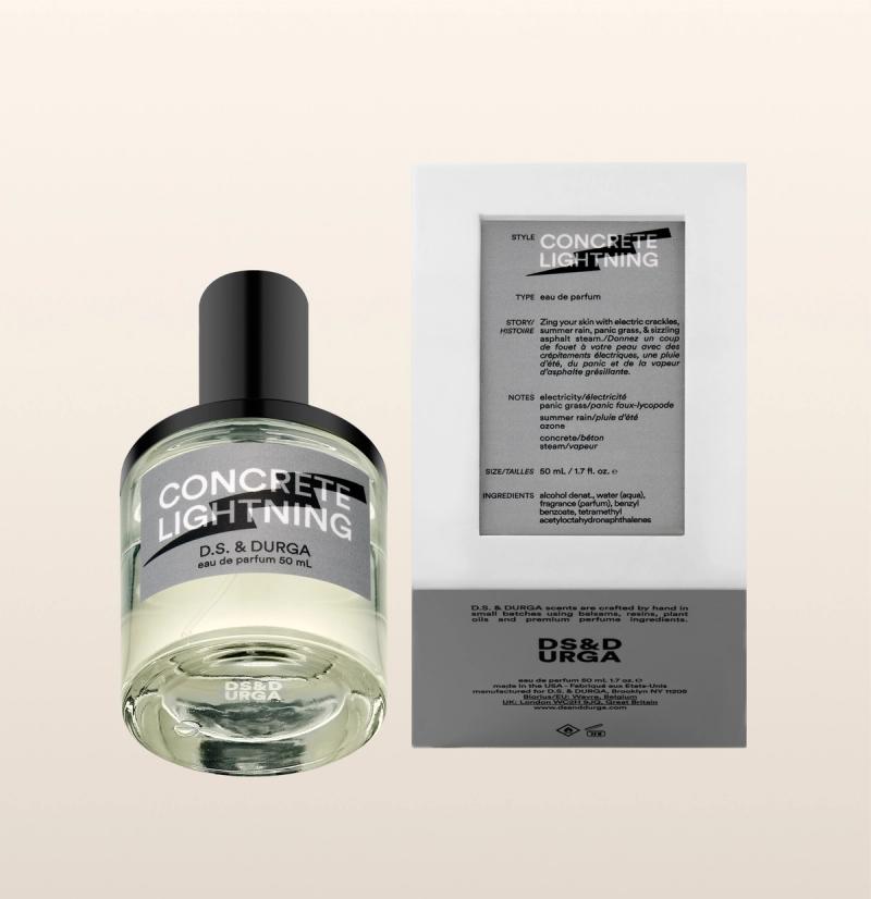 A bottle of D.S. & Durga Concrete Lightning eau de parfum sits next to its packaging, which displays the fragrance's name, description, and notes on a white background.