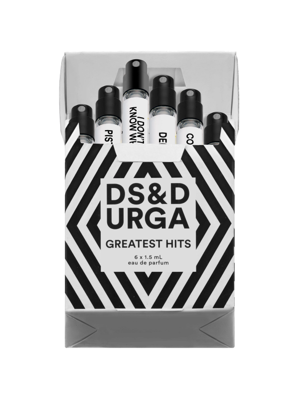 A collection of perfume bottles in a black and white striped bold packaging with the text "ds&durga greatest hits vol. 1" and a footnote indicating that each scent has a playlist on spotify.
