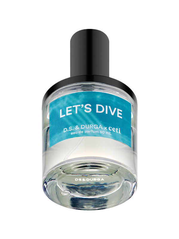 A clear glass bottle of perfume with a black cap. The label reads "LET'S DIVE," followed by "D.S. & DURGA x ceti eau de parfum 50 mL." The label features a gradient design in shades of blue and white.