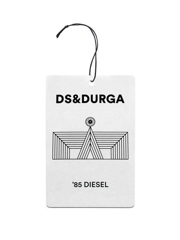 A hanging auto fragrance with the inscription "ds &amp; durga" and the scent name "85 diesel," adorned with an art deco style image.