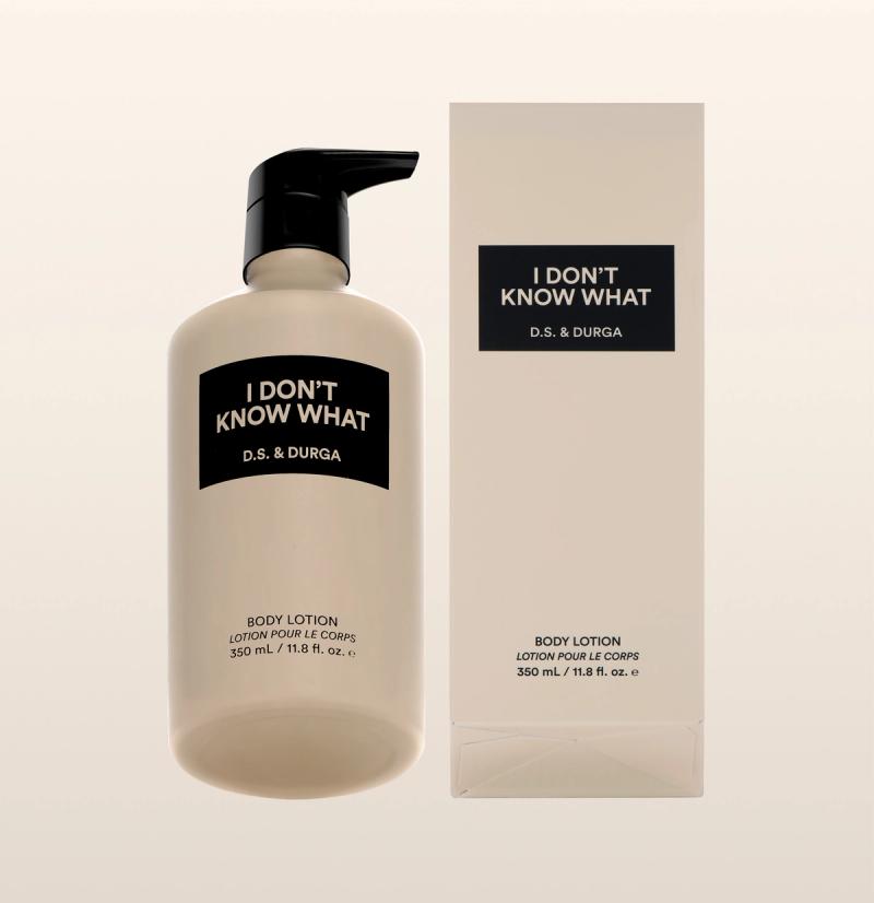 A beige bottle with a black pump labeled "I DON'T KNOW WHAT D.S. & DURGA" stands next to its matching rectangular box, both indicating the product is body lotion, 350 ml (11.8 fl. oz.).
