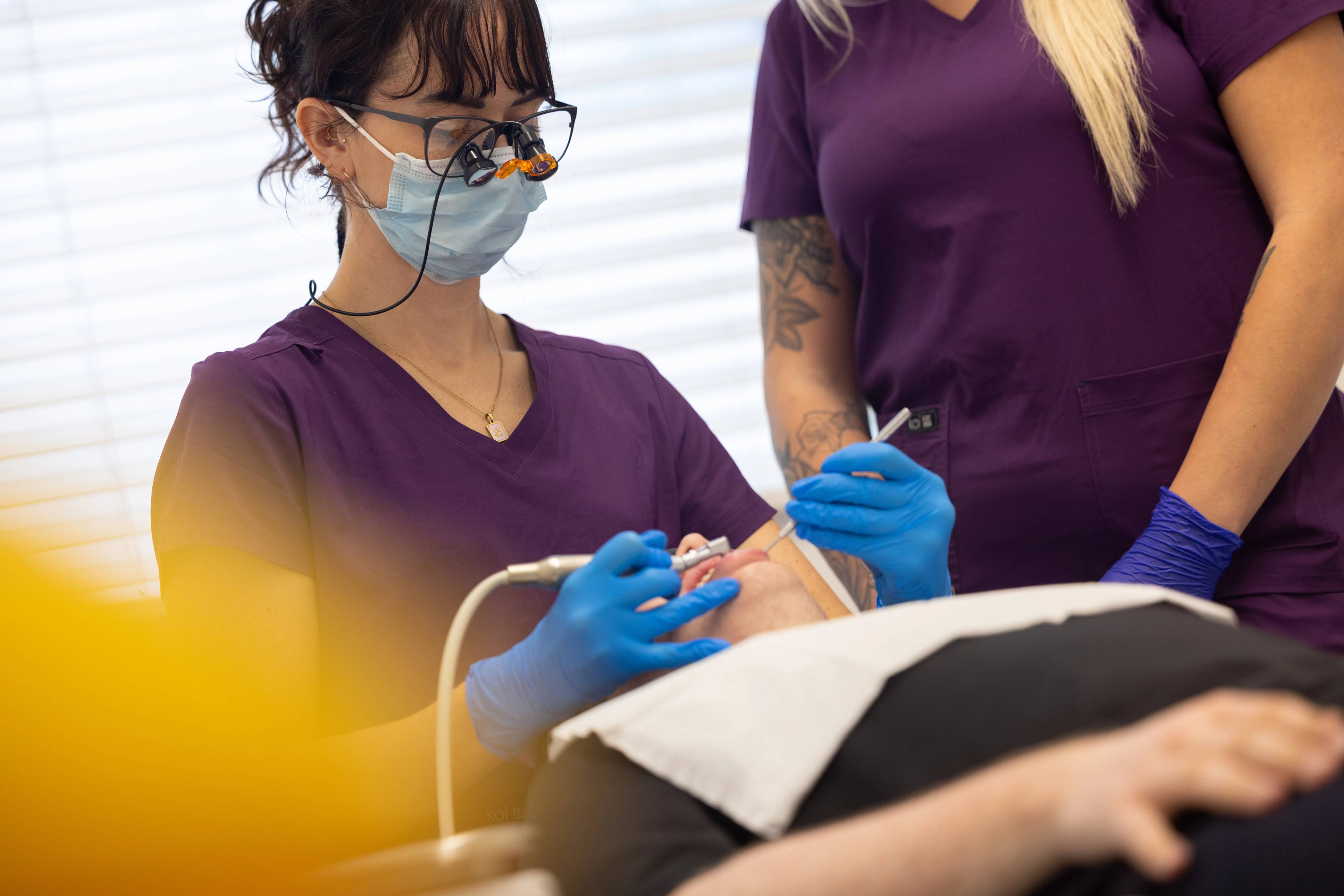 Dental therapist Lucy Steward inspects a patient's teeth