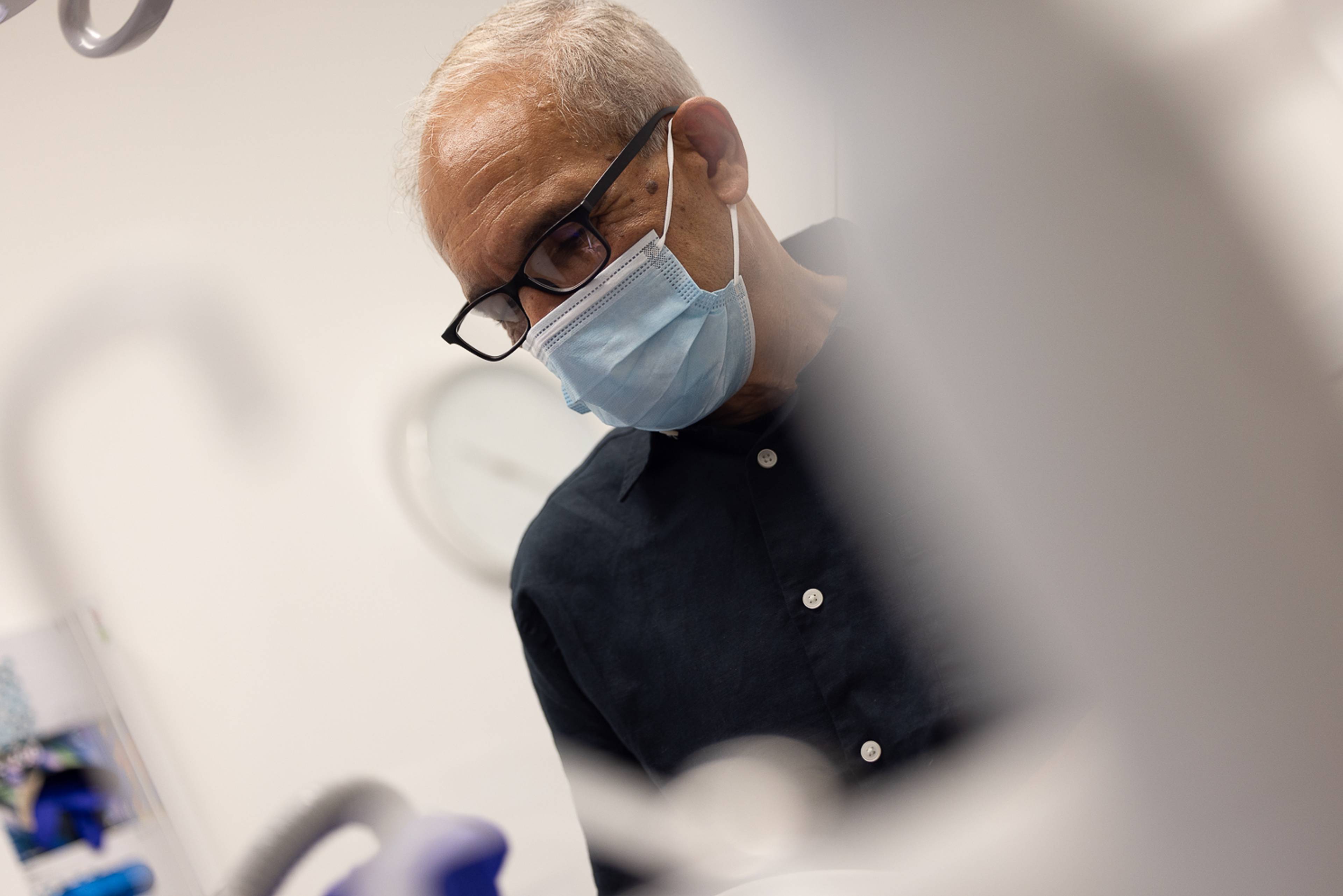 Dentist Shahriar Majlessi wearing a face mask in one of the clinic's treatment rooms