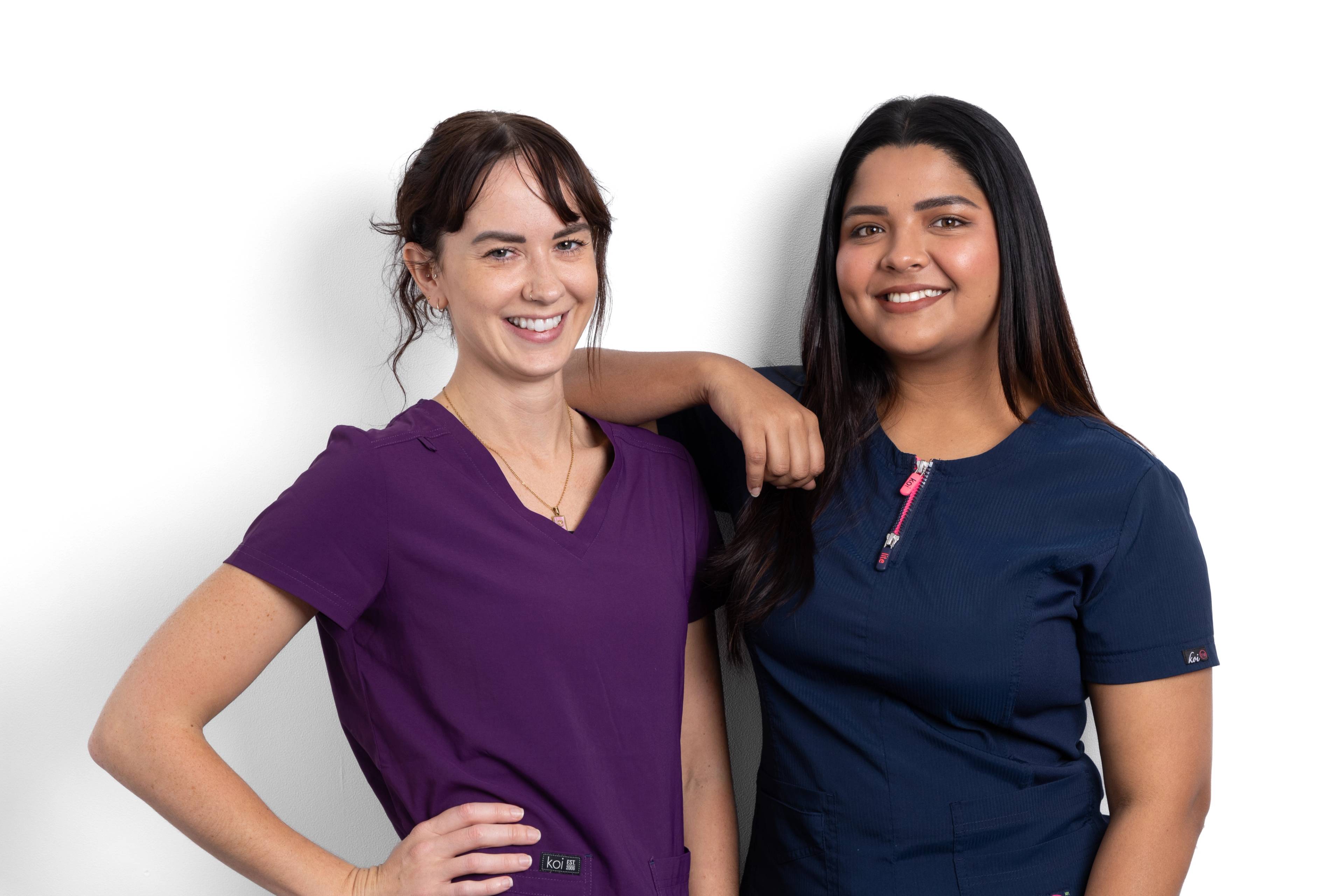 Dental therapists Lucy Steward and Gayathiri Devadas smiling at the camera