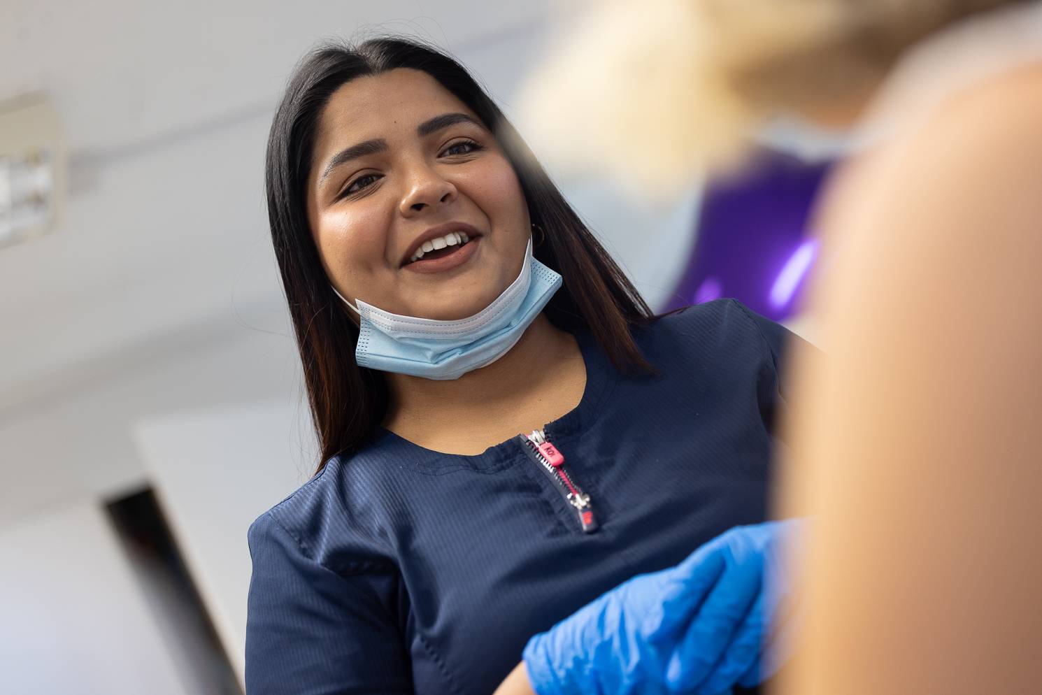 Dental therapist and hygienist Gayathiri Devadas speaking to a patient