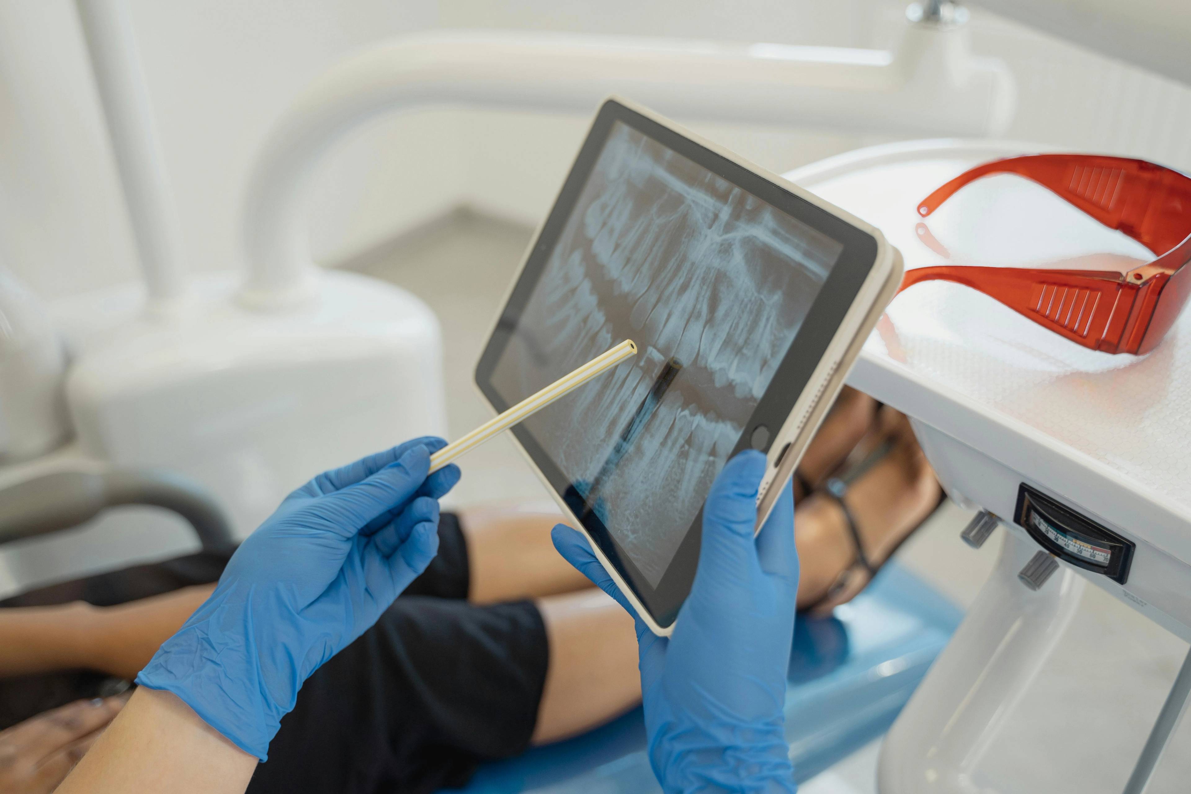 A stock image of a dentist showing a patient her x-ray