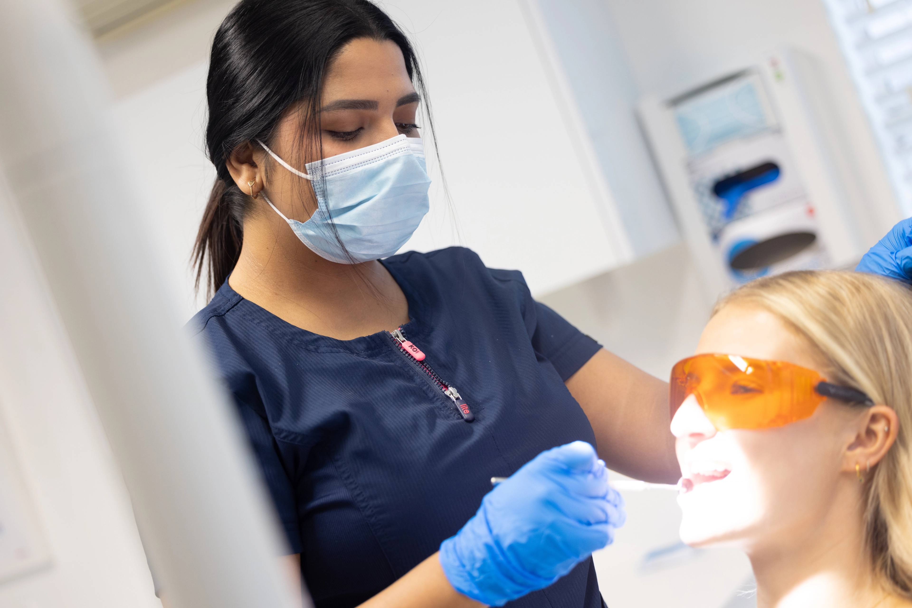 Dentist Gayathiri Devadas examining a patient's teeth