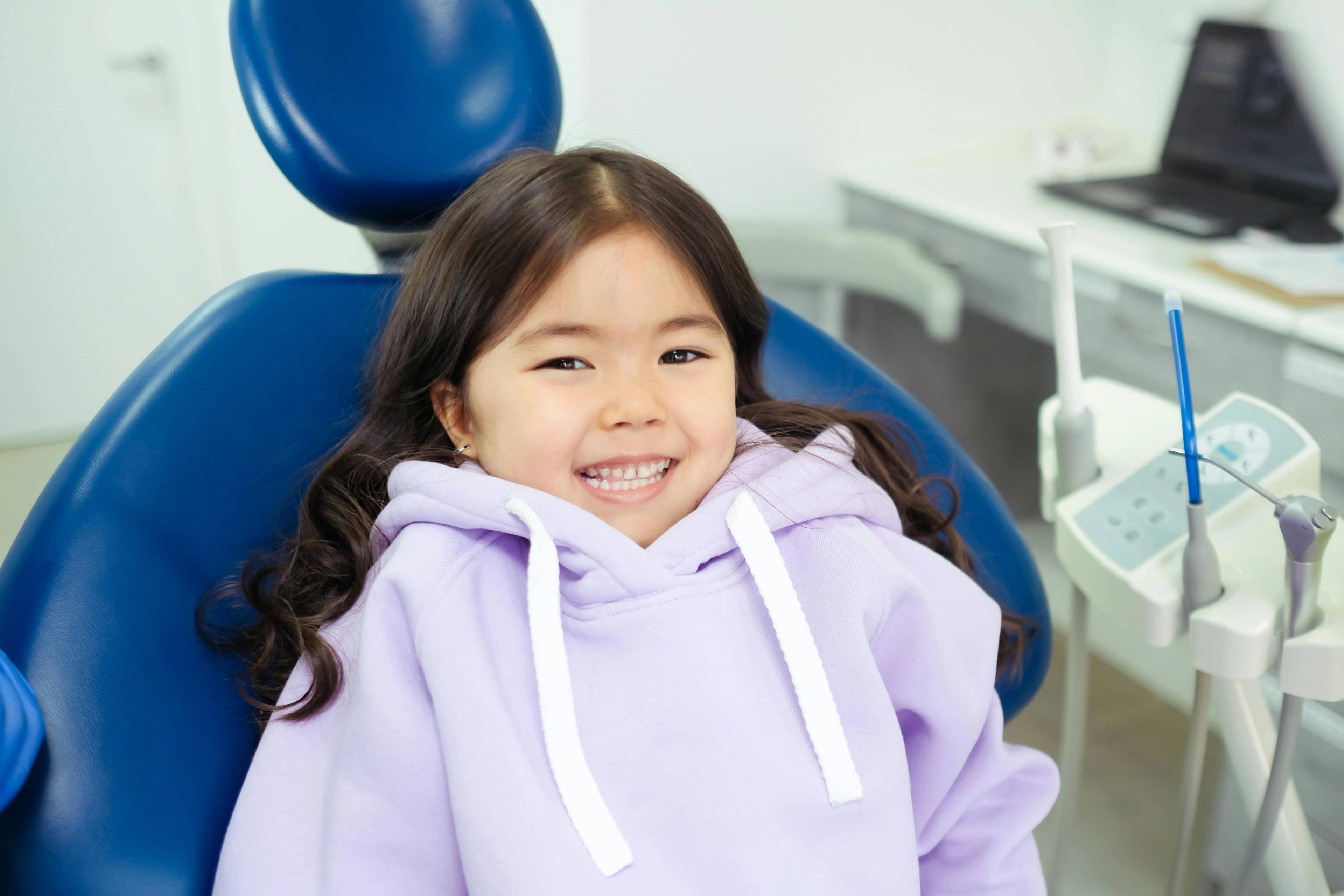 Stock image of a young girl in a dentist's treatment chair