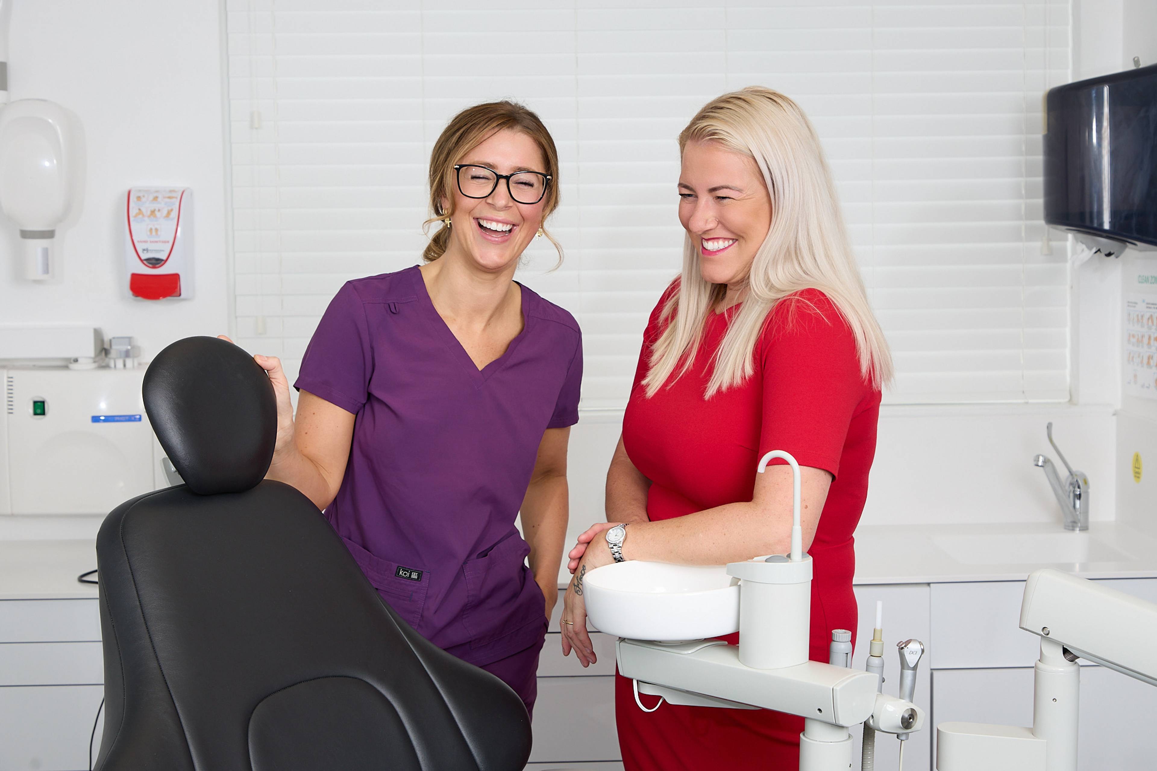Practice Manager Sophie laughs with dental nurse Jessica
