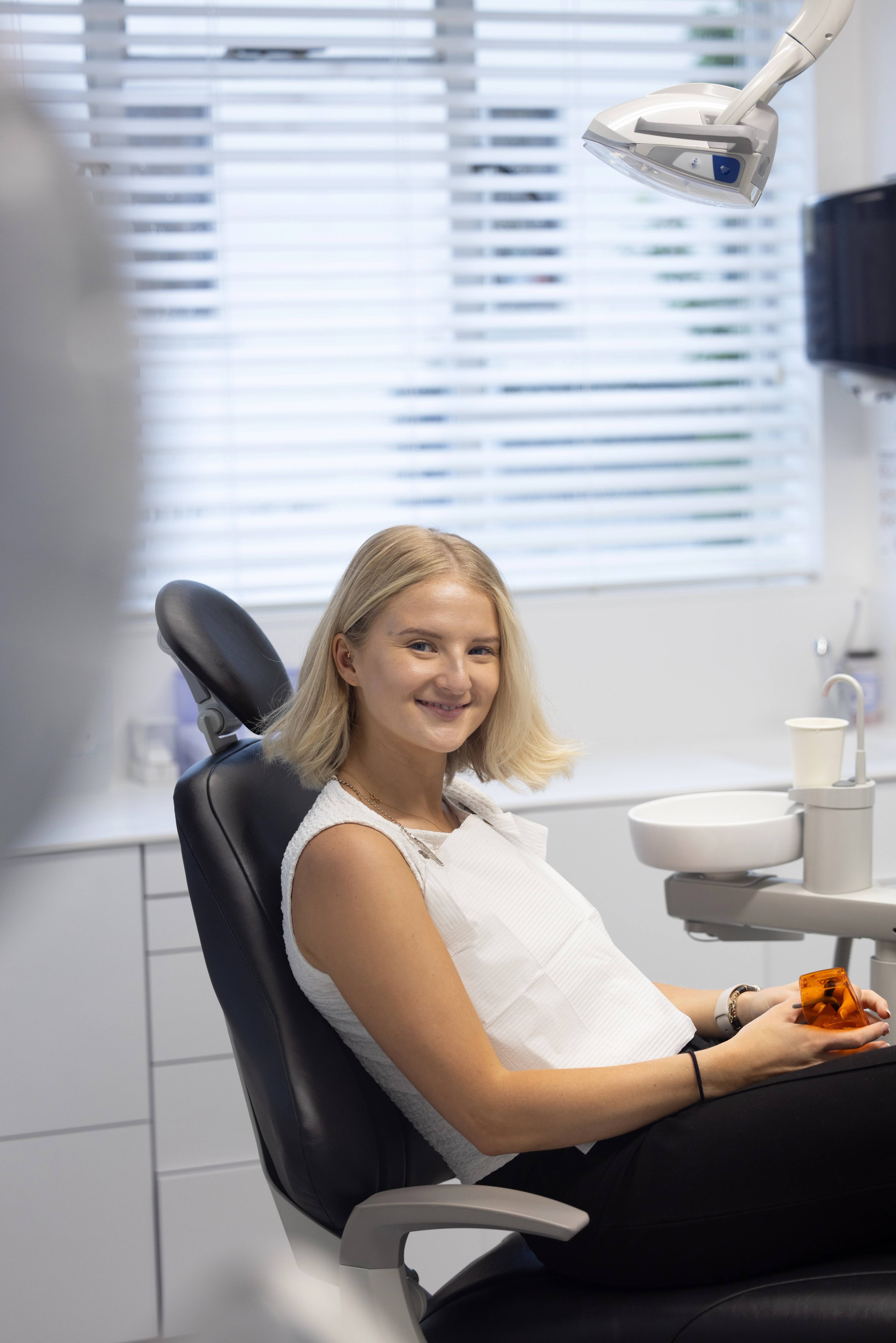 A patient smiling after receiving treatment at the clinic