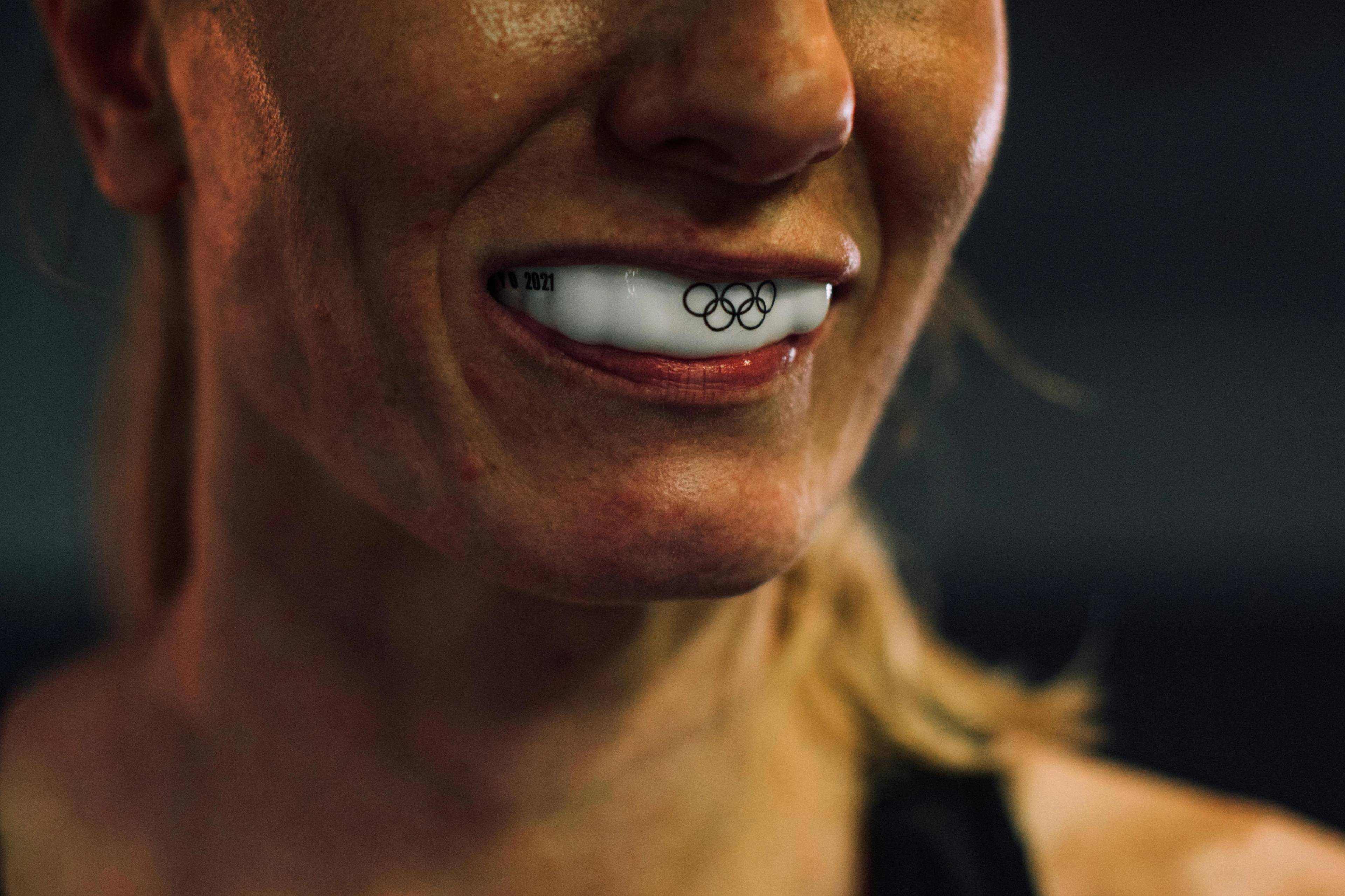 Close up photo of a female athlete wearing a gumshield