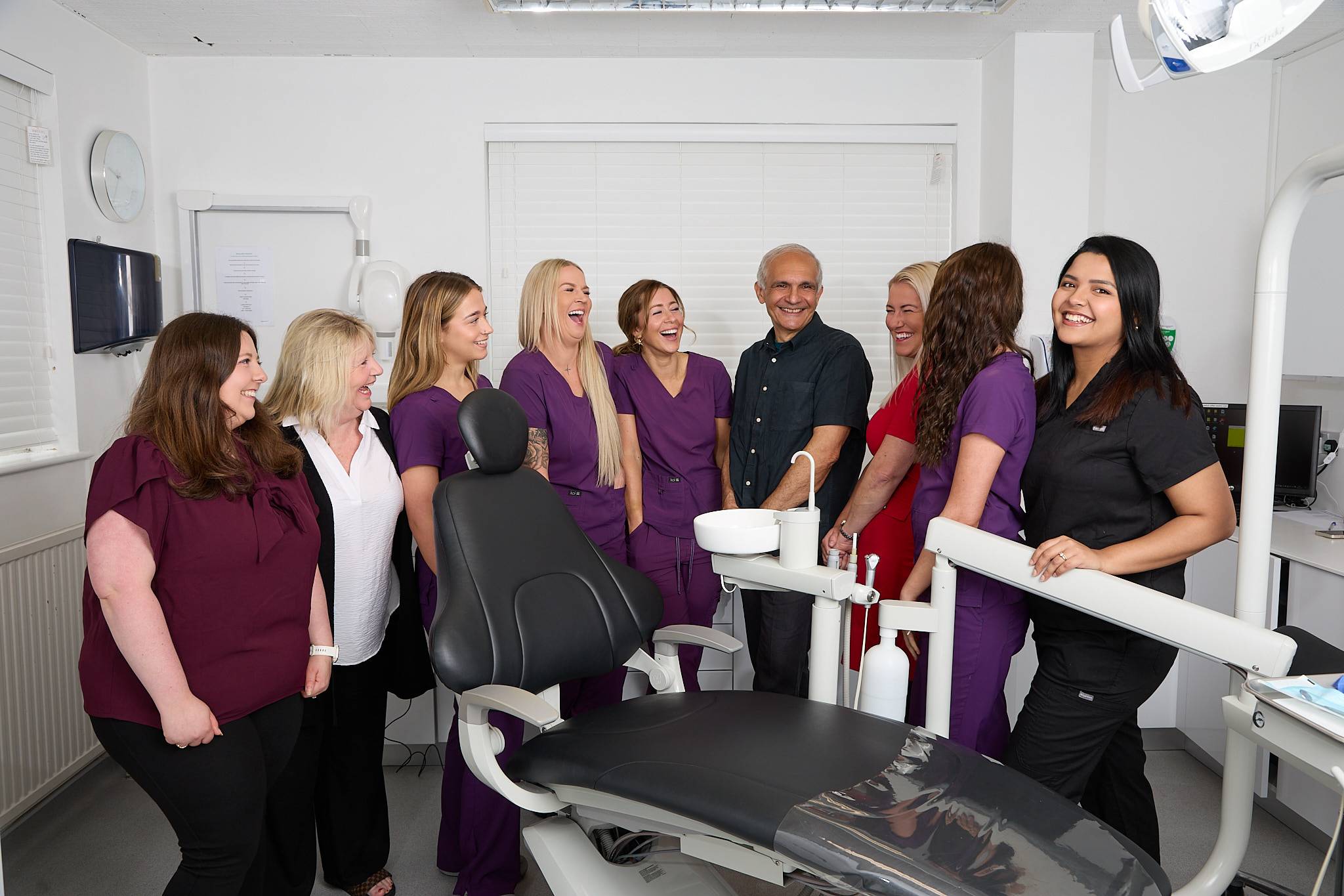 Part of the Plymouth City Centre Dental Practice team including dentist Shahriar Majlessi laughing together in a treatment room