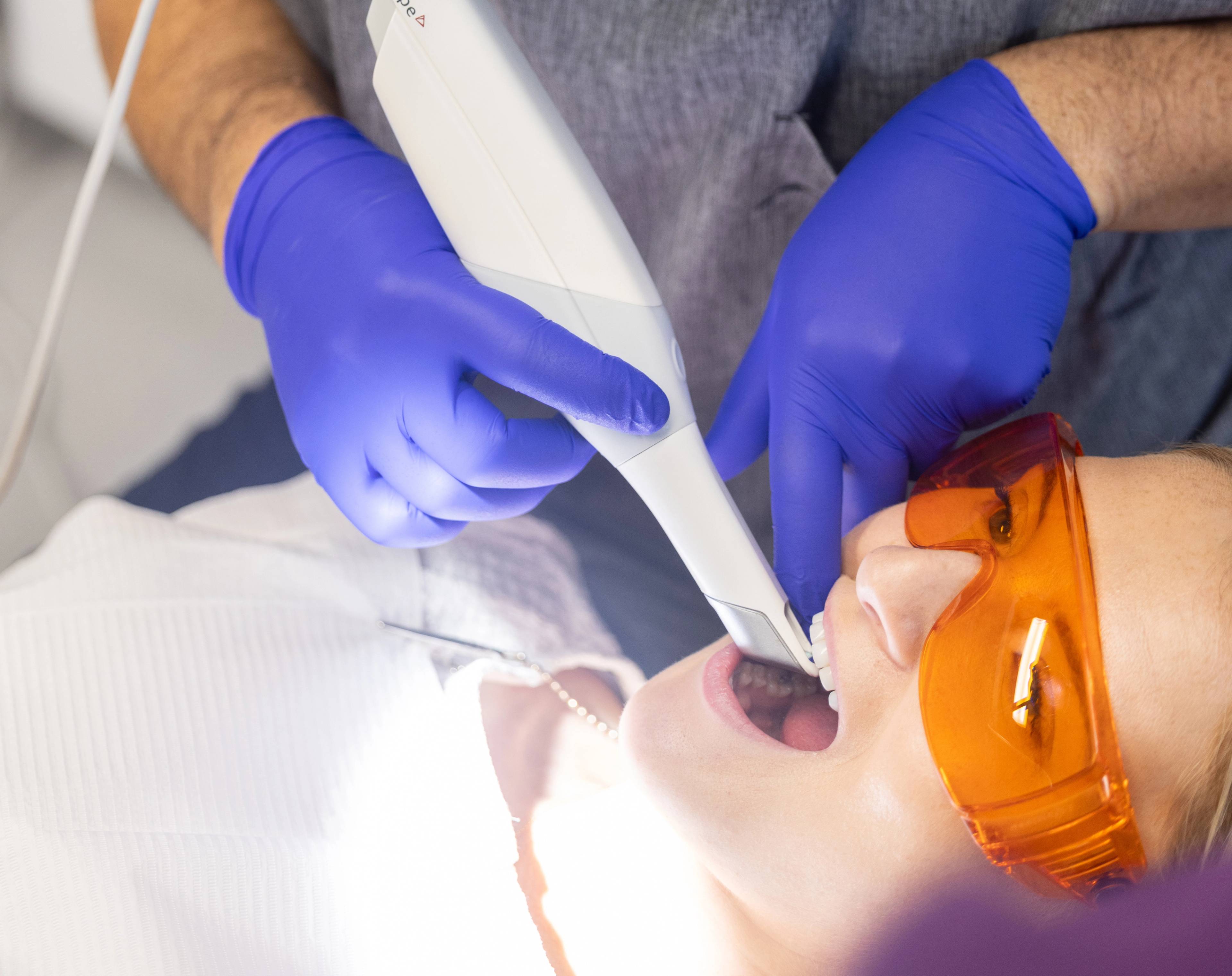 A patient having her mouth scanned by a dentist before Invisalign treatment