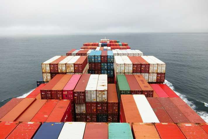 Shipping containers are seen on a large shipping vessel